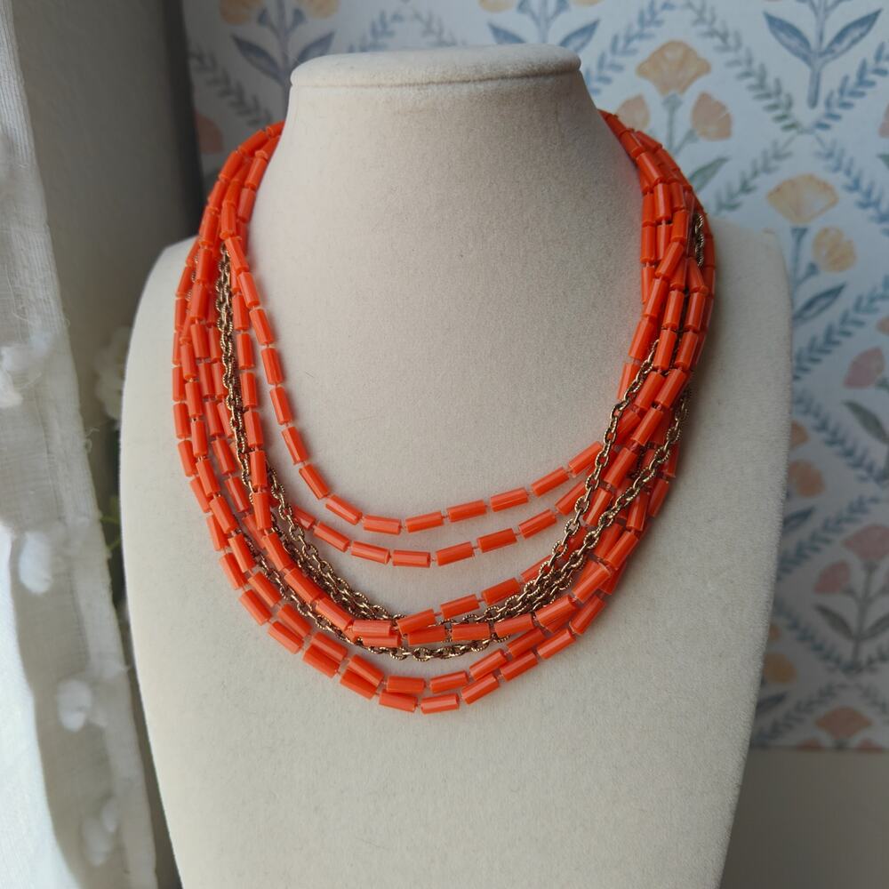 Vintage long gold tone and bright orange plastic beaded necklace